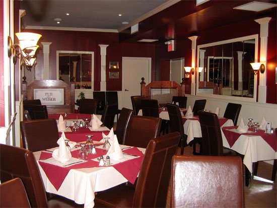Vijay's dining room with white tablecloths and leather chairs